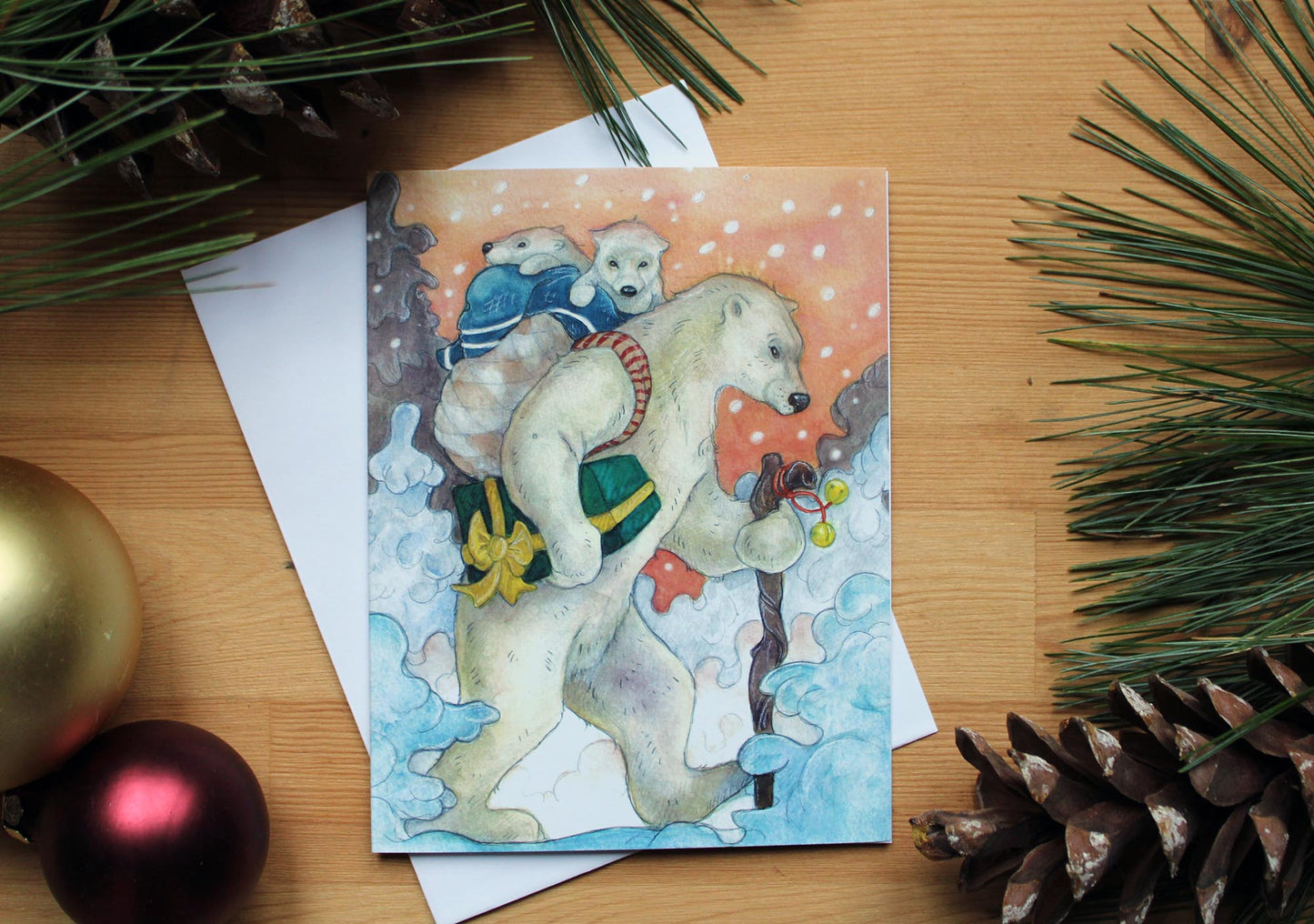 Polar Bear carrying two cubs in a basket. A christmas gift is  carried under arm. snow falls.