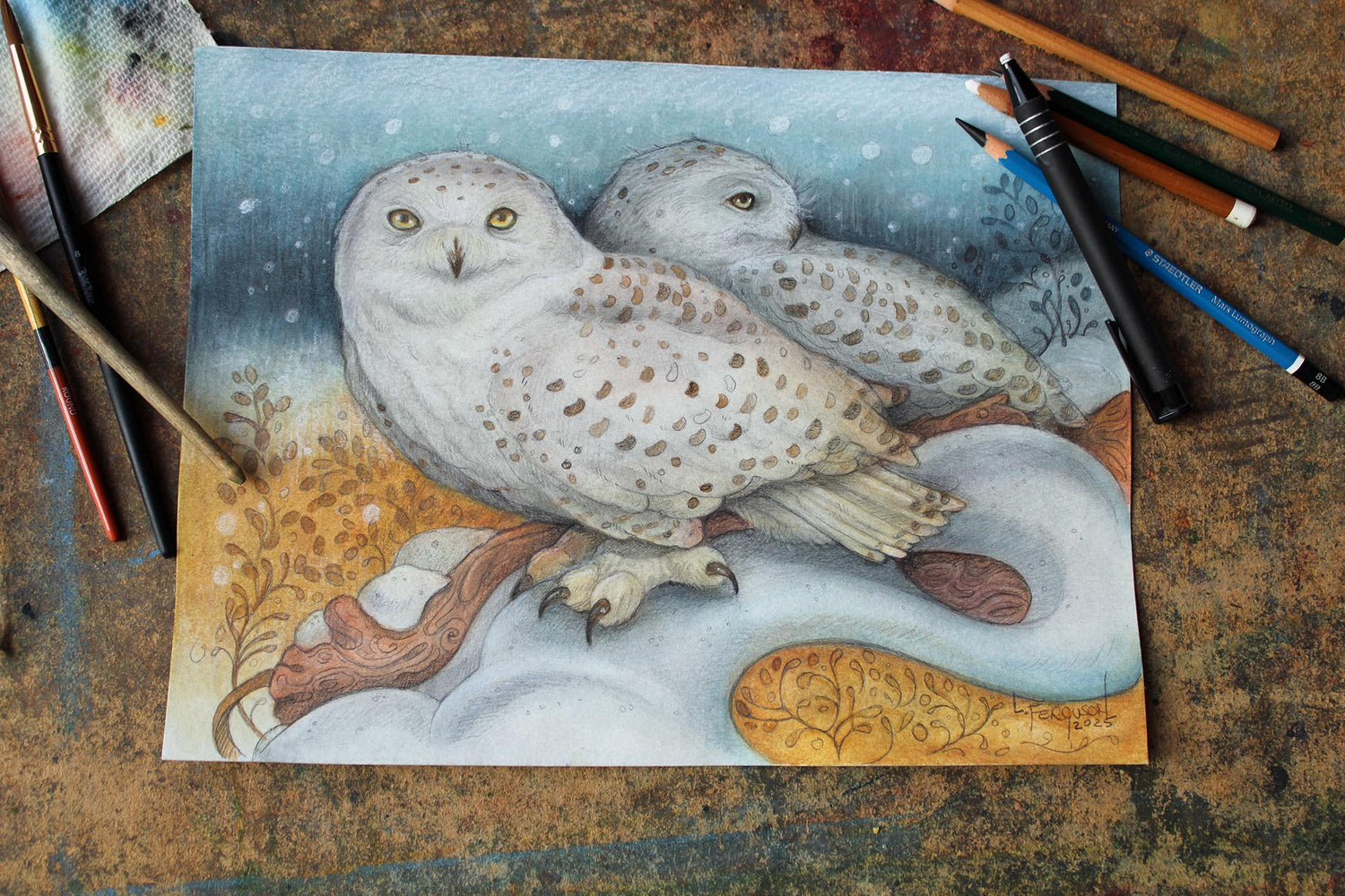 Mixed media artwork titled 'Stillness of Winter' featuring two snowy owls resting in a serene winter landscape. Created with watercolour paint, graphite pencil, charcoal, and conte on heavy cold-pressed watercolour paper, measuring 9x12 inches.