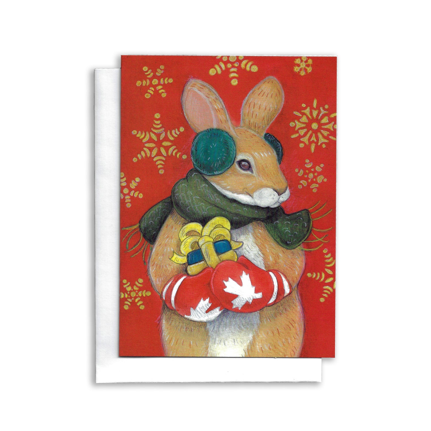 An illustrated Canadian Christmas Card of a rabbit holding a gift. He is wearing red mittens with white maple leaf on them. Red background with large gold snowflakes